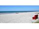 A relaxing view of a tranquil beach with soft sand, clear ocean water, and people enjoying the day at 19531 Gulf Blvd # 306, Indian Shores, FL 33785