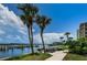 Picturesque community waterfront area with picnic tables, BBQ grills, and lovely palm trees at 19531 Gulf Blvd # 306, Indian Shores, FL 33785