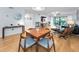 Open dining room with hardwood floors, neutral decor, and access to the balcony at 19531 Gulf Blvd # 306, Indian Shores, FL 33785