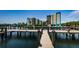 A long wooden dock leading to the waterfront condo complex, offers direct access to boating and scenic views at 19531 Gulf Blvd # 306, Indian Shores, FL 33785