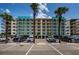Front exterior of condo building with meticulous landscaping, parking and attractive design at 19531 Gulf Blvd # 306, Indian Shores, FL 33785