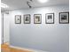 The hallway features wood floors and a series of framed artwork on the wall at 19531 Gulf Blvd # 306, Indian Shores, FL 33785