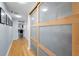 Hallway features wood floors, art on the walls, and sliding doors to maximize space at 19531 Gulf Blvd # 306, Indian Shores, FL 33785
