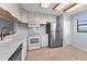 A well-lit kitchen featuring white cabinets and modern stainless steel appliances for efficient cooking at 19531 Gulf Blvd # 306, Indian Shores, FL 33785