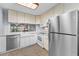 Bright kitchen featuring white cabinets and stainless steel appliances, ideal for culinary enthusiasts at 19531 Gulf Blvd # 306, Indian Shores, FL 33785