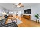 Inviting living room with hardwood floors, a ceiling fan, and a large TV at 19531 Gulf Blvd # 306, Indian Shores, FL 33785