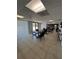 Bright lounge area featuring tile floors, tables, chairs, a bookcase and well-lit, suspended ceilings at 19531 Gulf Blvd # 306, Indian Shores, FL 33785