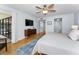 This main bedroom features wood floors, a ceiling fan, a sliding glass door to the balcony, and ensuite bathroom at 19531 Gulf Blvd # 306, Indian Shores, FL 33785