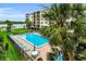 Pool area with lounge chairs and a beautiful view of the intercoastal waters at 19531 Gulf Blvd # 306, Indian Shores, FL 33785
