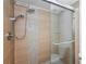 Modern tiled shower with updated showerhead and sliding glass doors for a stylish bathroom at 19531 Gulf Blvd # 306, Indian Shores, FL 33785