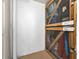 Caged storage units with metal mesh doors and wooden frames, adjacent to a painted cinder block wall at 19531 Gulf Blvd # 306, Indian Shores, FL 33785