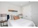 A serene bedroom featuring a plush bed, decorative pillows, and elegant lamps on side tables at 1959 Longliner Loop, Wesley Chapel, FL 33543