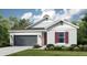 Charming one-story home with a two-car garage, landscaped yard, and covered entry at 1959 Longliner Loop, Wesley Chapel, FL 33543