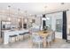 Modern kitchen with stainless steel appliances, a center island, and an adjacent dining area at 1959 Longliner Loop, Wesley Chapel, FL 33543