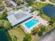 A high-angle view shows a large pool and jacuzzi surrounded by lounge chairs next to the clubhouse at 2333 Feather Sound Dr # A107, Clearwater, FL 33762