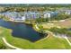Aerial view of condos surrounded by a scenic golf course, lush greenery, and tranquil waters at 2333 Feather Sound Dr # A107, Clearwater, FL 33762
