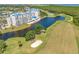 Stunning aerial view of a modern condo community with a golf course and beautiful landscaping at 2333 Feather Sound Dr # A107, Clearwater, FL 33762