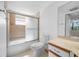 Cozy bathroom features a shower-tub combo with glass doors and a mirrored vanity at 2333 Feather Sound Dr # A107, Clearwater, FL 33762