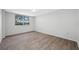 Bedroom boasts wood-look flooring, ceiling fan, and large window at 2333 Feather Sound Dr # A107, Clearwater, FL 33762