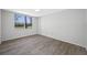 Bedroom with wood-look flooring, ceiling fan, and large window at 2333 Feather Sound Dr # A107, Clearwater, FL 33762