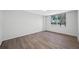 Bedroom with wood-look flooring, ceiling fan, and large window at 2333 Feather Sound Dr # A107, Clearwater, FL 33762