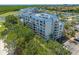 Exterior shot showcasing a multi-story condo building with a view of the surrounding nature at 2333 Feather Sound Dr # A107, Clearwater, FL 33762
