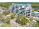 Exterior daytime view of condo building with covered entryway, mature trees and landscaping at 2333 Feather Sound Dr # A107, Clearwater, FL 33762