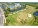 An aerial view of a golf course with green grass and a nearby apartment complex at 2333 Feather Sound Dr # A107, Clearwater, FL 33762