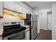 Efficient kitchen with oven and stainless steel refrigerator with vinyl flooring at 2333 Feather Sound Dr # A107, Clearwater, FL 33762