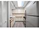 Efficient kitchen featuring white cabinetry and stainless steel refrigerator at 2333 Feather Sound Dr # A107, Clearwater, FL 33762