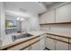 Kitchen view to the living area, features sink, dishwasher, and laminate flooring at 2333 Feather Sound Dr # A107, Clearwater, FL 33762
