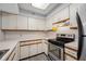 Bright kitchen with updated appliances, white cabinets, and ample counter space at 2333 Feather Sound Dr # A107, Clearwater, FL 33762