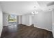 Living room with sliding glass door to balcony, wood-look flooring and modern lighting at 2333 Feather Sound Dr # A107, Clearwater, FL 33762