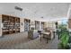 Resident lounge area features many bookshelves, plants, and neutral colored furniture at 2333 Feather Sound Dr # A107, Clearwater, FL 33762