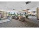 Community lounge area features neutral colored furniture, plants, and large windows at 2333 Feather Sound Dr # A107, Clearwater, FL 33762