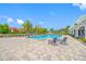 A pool with lounge chairs and a blue sky background at 2333 Feather Sound Dr # A107, Clearwater, FL 33762