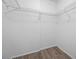 Walk-in closet features wire shelving and wood-look flooring at 2333 Feather Sound Dr # A107, Clearwater, FL 33762