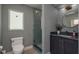 Contemporary bathroom with glass enclosed shower, modern vanity, and stylish wallpaper at 2395 Campbell Rd, Clearwater, FL 33765
