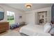 Inviting bedroom with a comfortable bed, a stylish blue trunk, and a view of the outdoors at 2395 Campbell Rd, Clearwater, FL 33765
