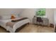 Comfortable bedroom with a dedicated desk area and natural light, creating a perfect space for relaxation and study at 2395 Campbell Rd, Clearwater, FL 33765