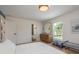 Bright bedroom boasts stylish furnishings, a light hardwood floor, and an ensuite bathroom for added convenience at 2395 Campbell Rd, Clearwater, FL 33765