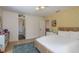 Bright bedroom boasts a rattan bed frame, yellow accent wall, and natural light with hallway access at 2395 Campbell Rd, Clearwater, FL 33765