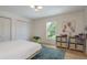 Cozy bedroom features a plush rug, ample natural light, and built-in storage for an organized space at 2395 Campbell Rd, Clearwater, FL 33765