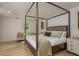 Spacious bedroom boasts a four-poster bed, sitting area, wood floors, and ample natural light at 2395 Campbell Rd, Clearwater, FL 33765
