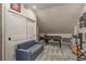 Upstairs bonus room featuring a sitting area, foosball table, and storage shelves at 2395 Campbell Rd, Clearwater, FL 33765