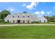Charming single-story home with a well manicured lawn, brick driveway, and welcoming entrance, nestled beneath a picturesque sky at 2395 Campbell Rd, Clearwater, FL 33765