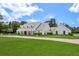 Beautiful white home with well manicured front lawn and charming curb appeal at 2395 Campbell Rd, Clearwater, FL 33765