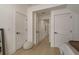 Hallway view shows multiple doorways and white trim, showcasing the home's layout and access to different rooms at 2395 Campbell Rd, Clearwater, FL 33765