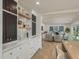 Modern kitchen with marble countertops and backsplash, wood accents, and view to the living room at 2395 Campbell Rd, Clearwater, FL 33765