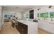 Modern kitchen with marble countertops, dark wood cabinets, and a view to the living room at 2395 Campbell Rd, Clearwater, FL 33765